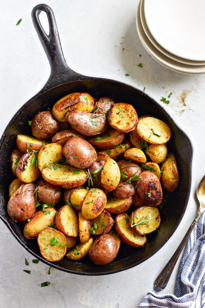 overhead photo of traeger roasted potatoes being served in a cast iron pan