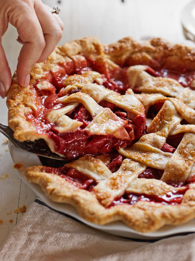 woman serving a strawberry rhubarb pie