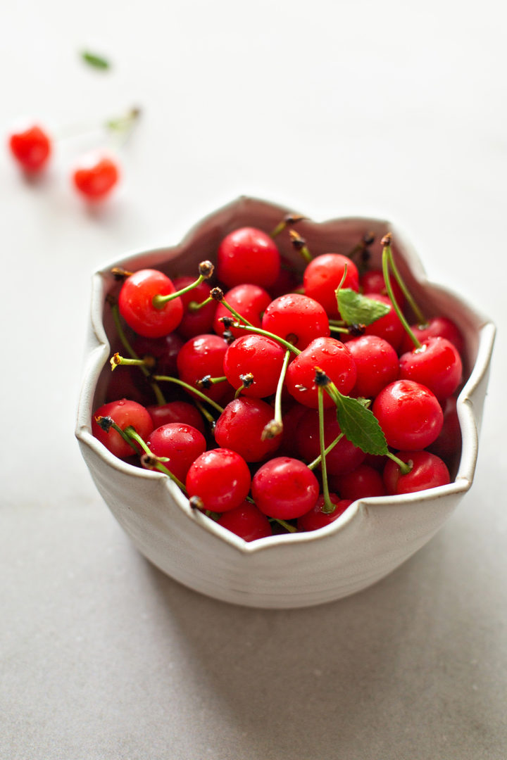 a bowl of fresh tart cherries