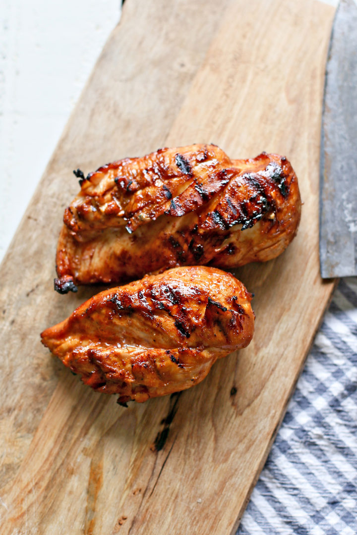 grilled bbq chicken resting on a cutting board after cooking