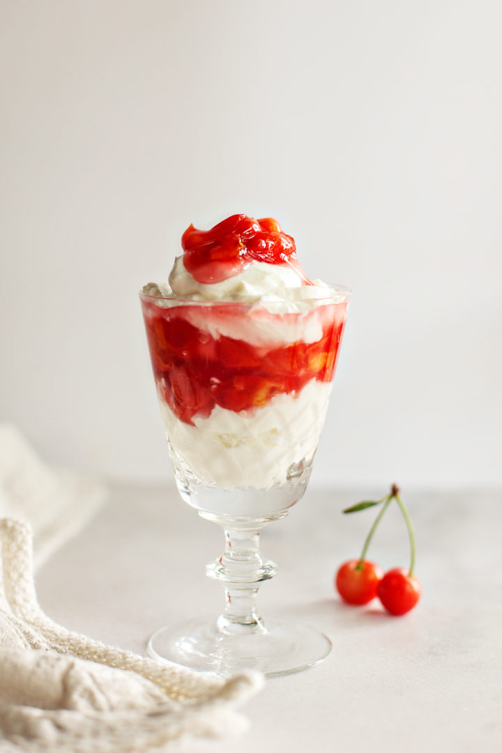 parfait made with homemade cherry pie filling in a dessert glass