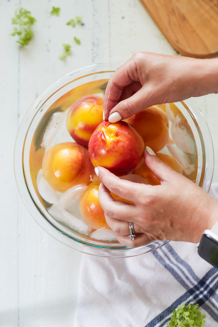 woman demonstrating how to peel peaches