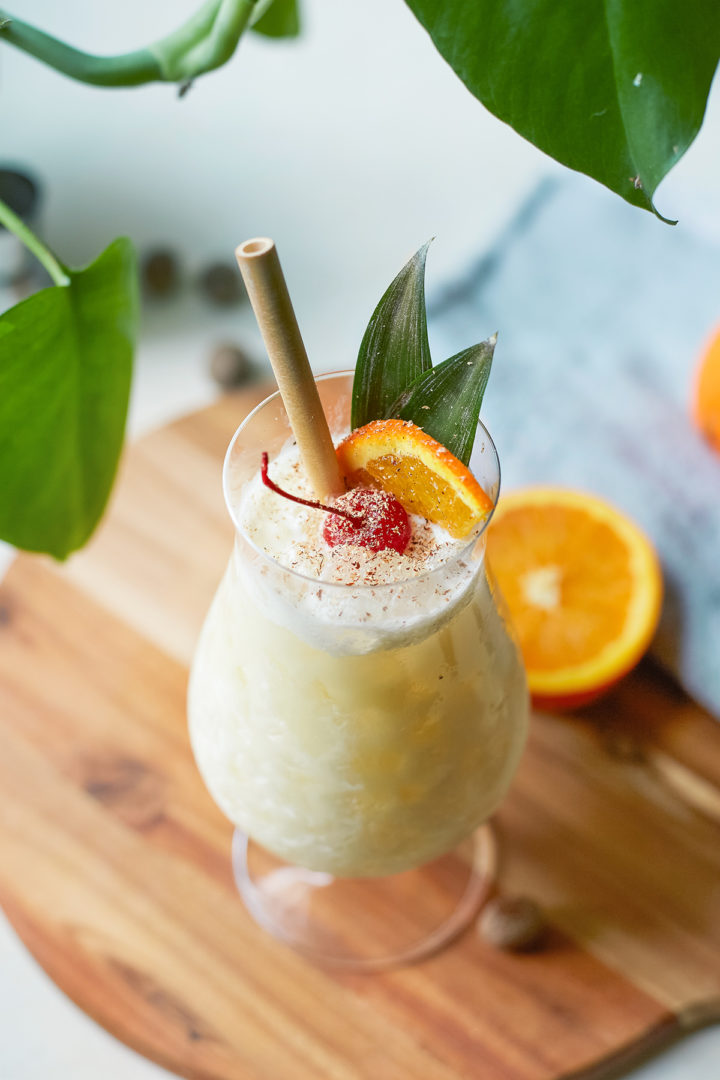 close up of a painkiller drink in a glass with straw