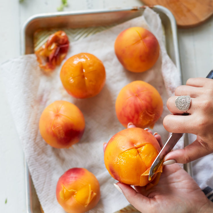 woman peeling a peach