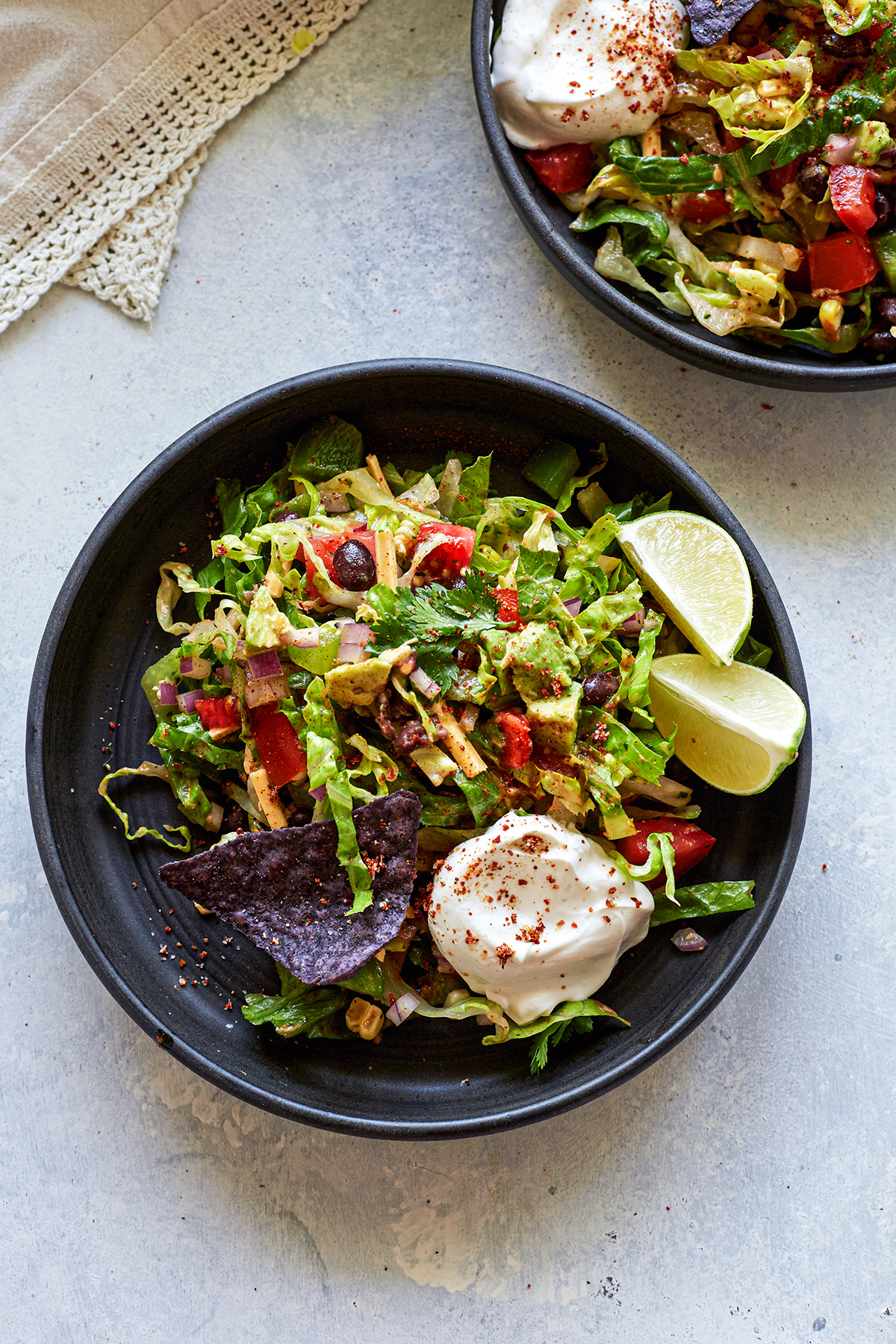 overhead photo of vegetarian taco salad on two black plates