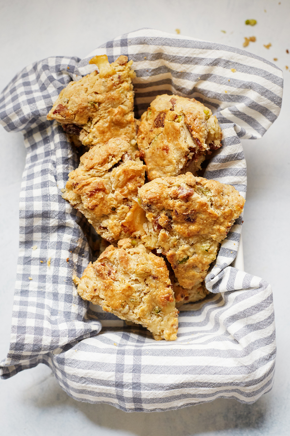 a batch of cheese and bacon scones wrapped in a towel