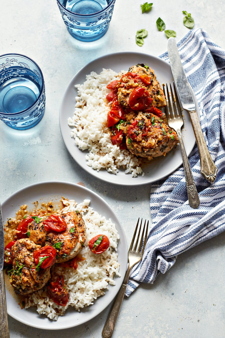 two plates of herbs de Provence chicken serve with rice