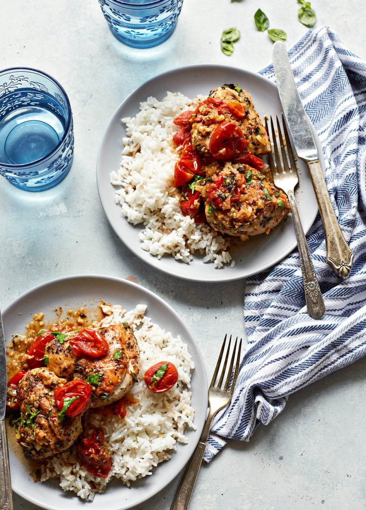 rice served with herbs de provence chicken on two plates