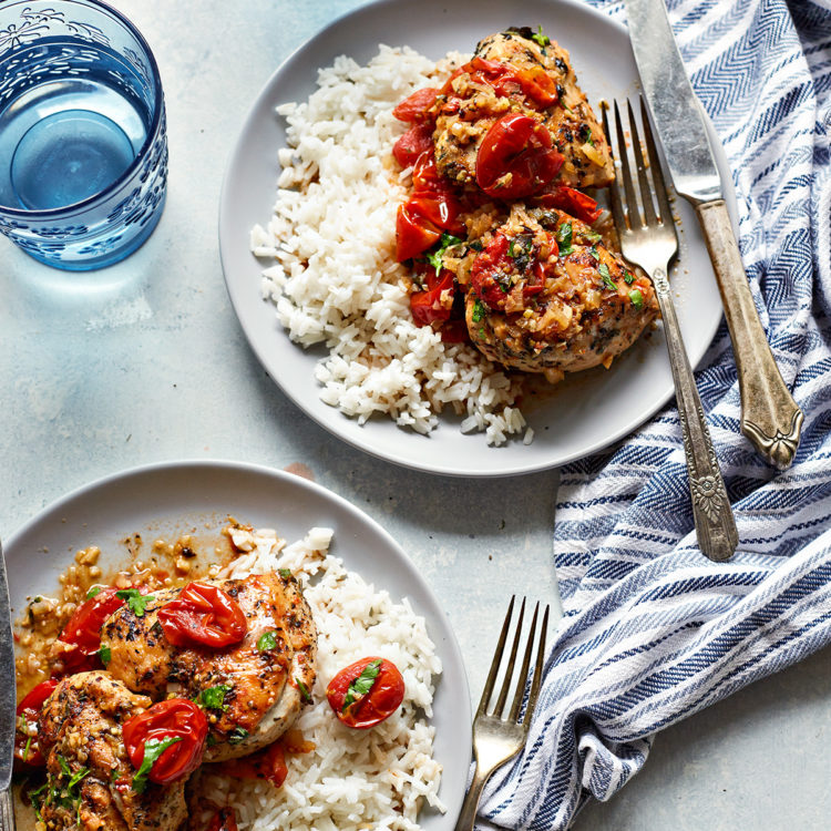 rice served with herbs de provence chicken on two plates