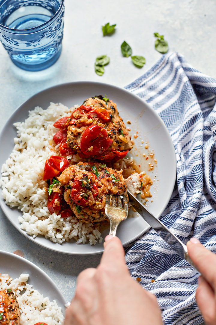 woman eating herbs de Provence chicken with grape tomatoes