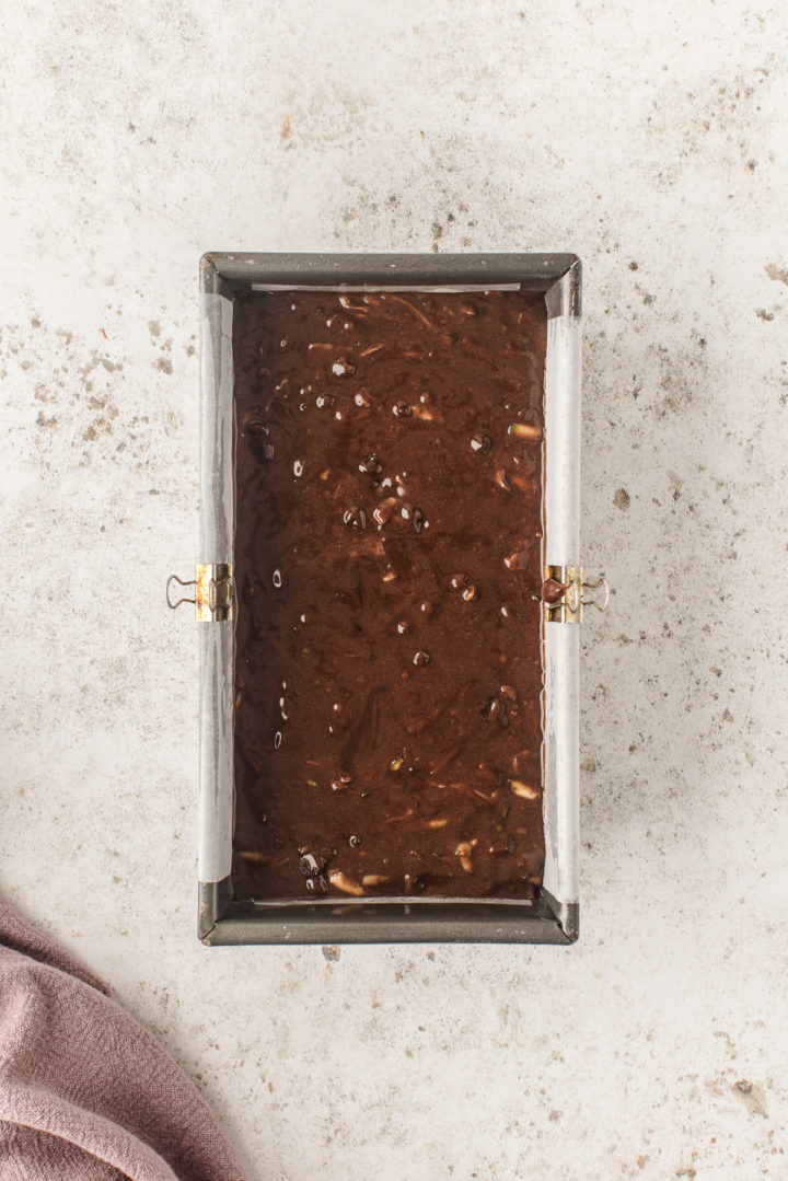 easy chocolate zucchini bread batter in a lined cake pan