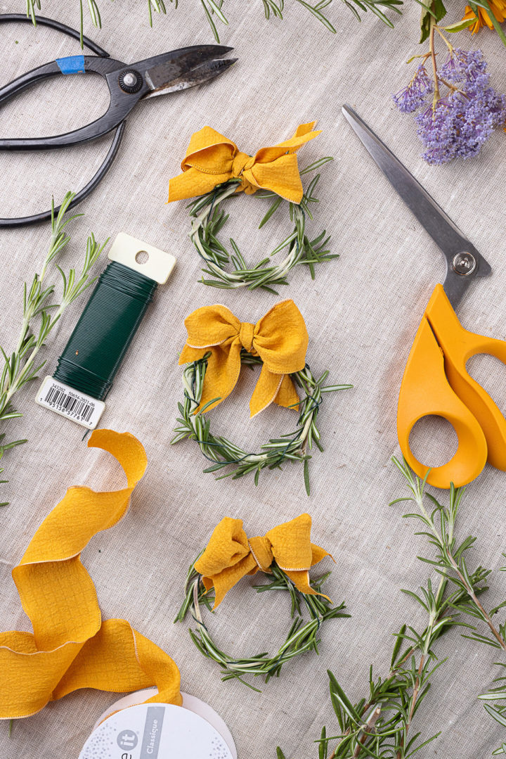 three fresh rosemary wreaths with bows