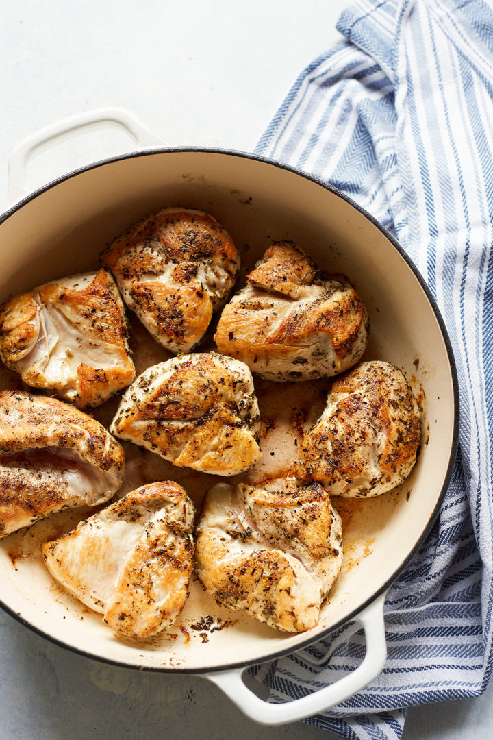 chicken breasts browning in a pan