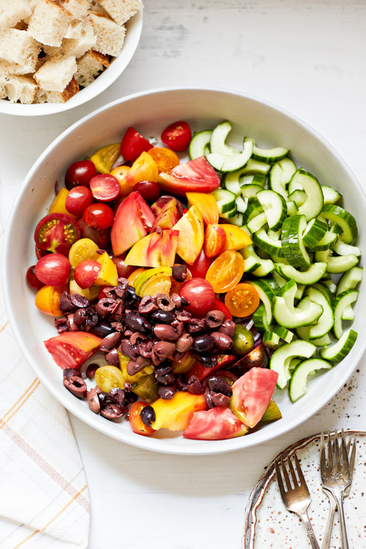 olives, tomatoes, and cucumbers in a bowl