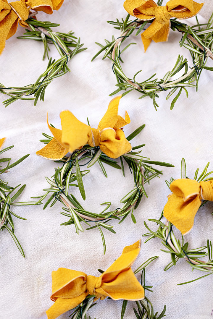 diy rosemary wreaths on a white tablecloth