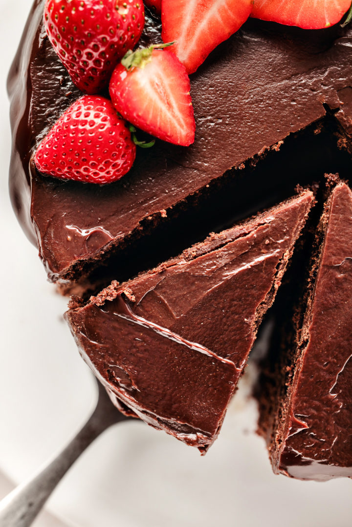 slicing a chocolate ganache filled cake