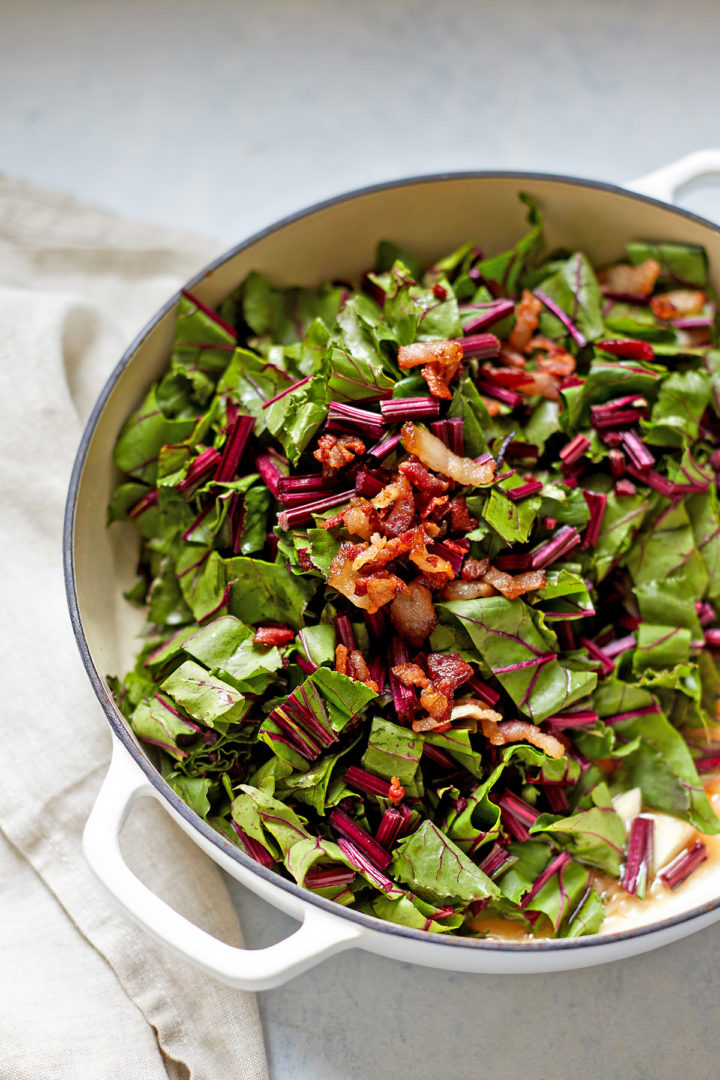 beet greens and bacon in a braiser pan