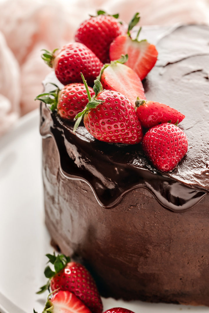 chocolate ganache filled cake decorated with fresh strawberries