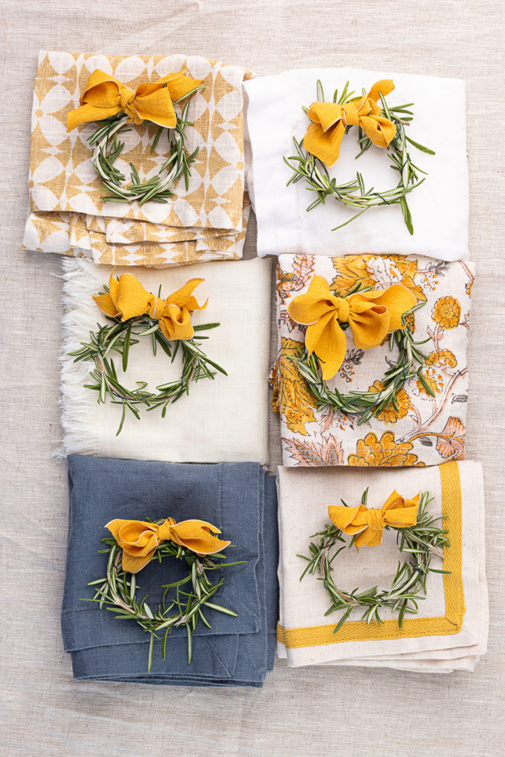 DIY Thanksgiving place cards made from rosemary on folded cloth napkins