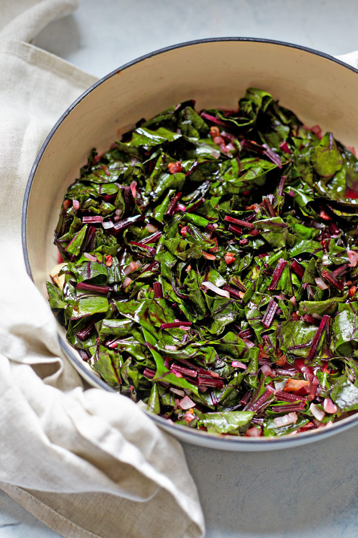 beet greens cooking in a braiser pan