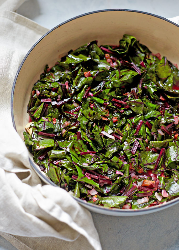 beet greens cooked with bacon and balsamic in a pan