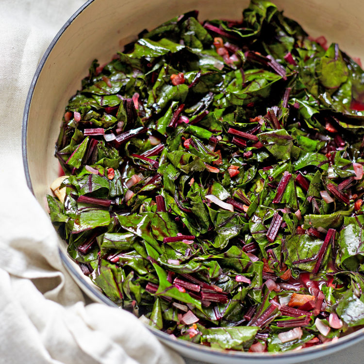 beet greens cooked with bacon and balsamic in a pan