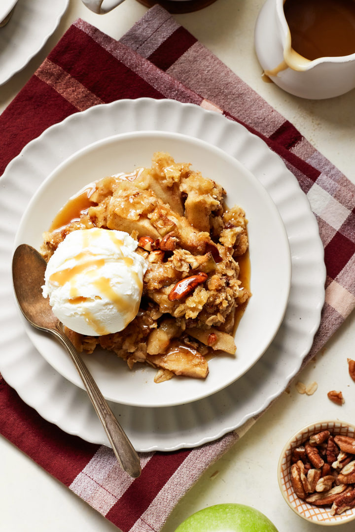 vanilla ice cream on a plate with apple caramel crisp