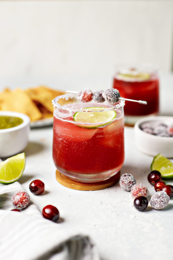 glasses of cranberry margaritas with lime and cranberry garnish