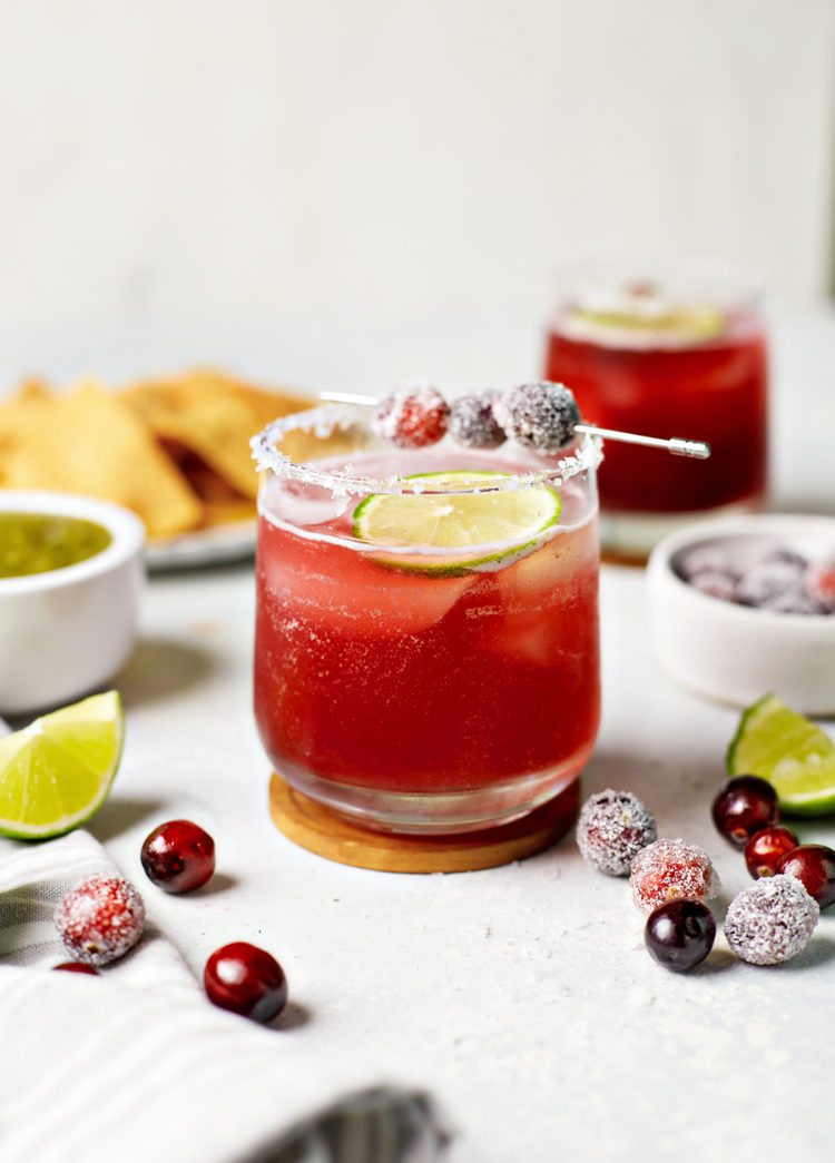 glasses of cranberry margaritas with lime and cranberry garnish