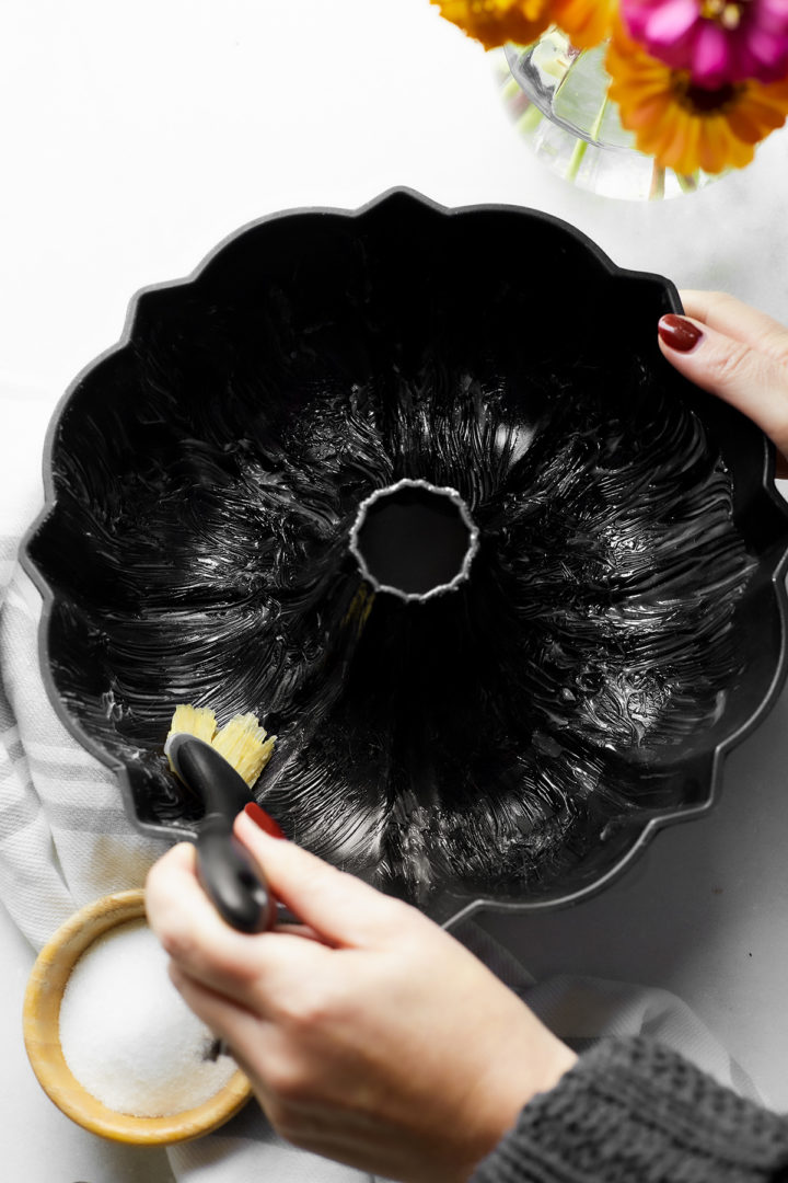 woman greasing a bundt pan with shortening