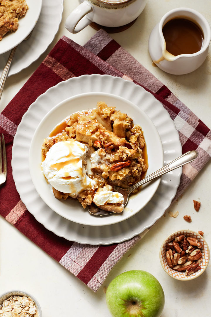 vanilla ice cream on a plate with caramel apple crisp