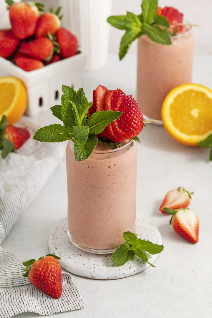 smoothie with passion fruit in glasses with strawberry garnish