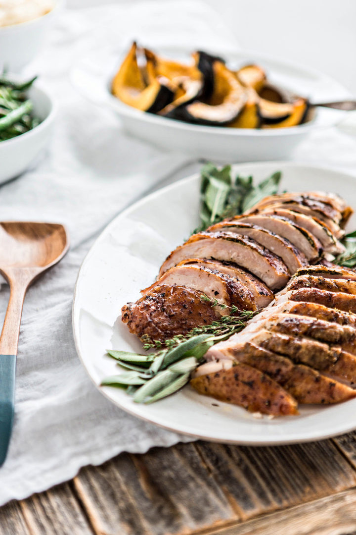 seasoned and roasted turkey sliced on a platter