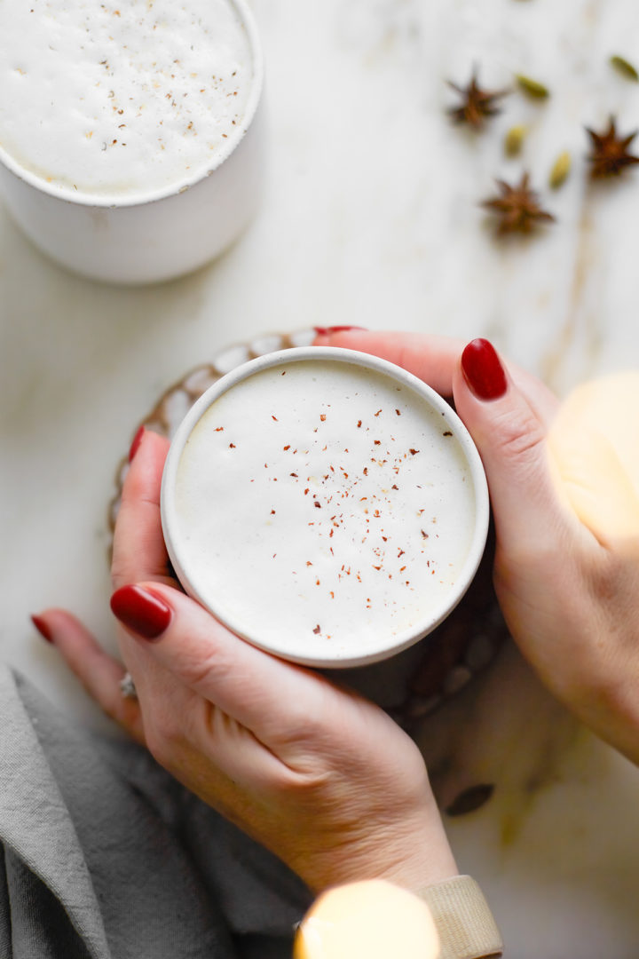 woman holding a mug of chai latte