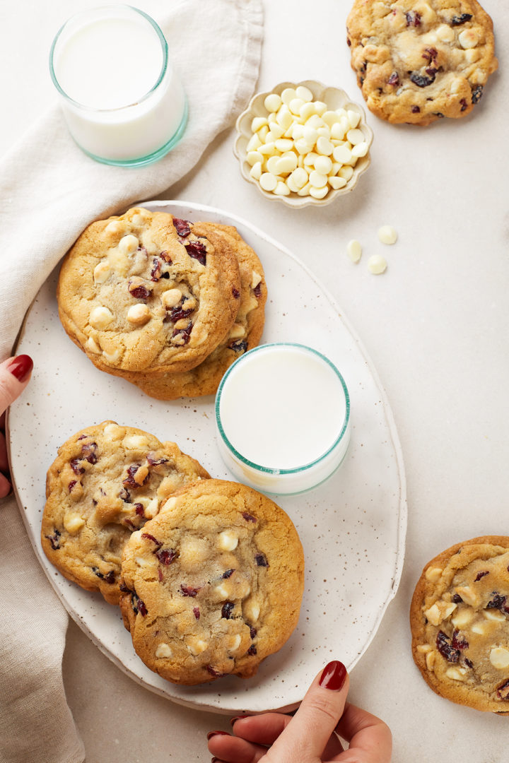 woman holding a plate of dried cranberry cookies