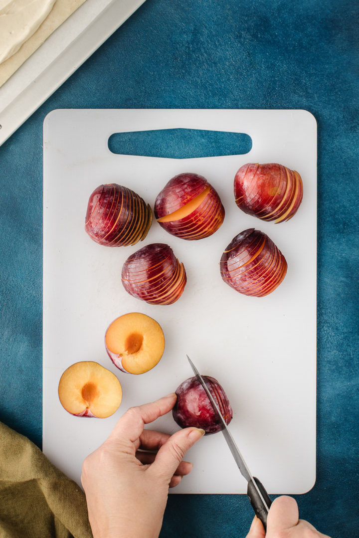 woman slicing plums for a plum tart recipe