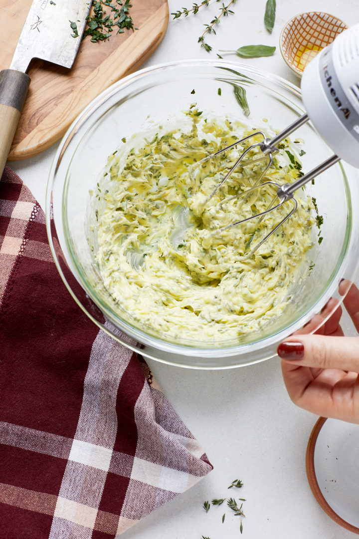 woman making herb butter for smoked turkey breast