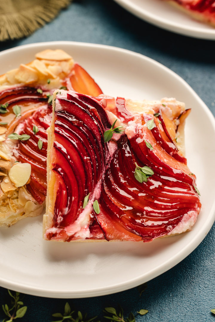 two slices of a plum tart on a white plate