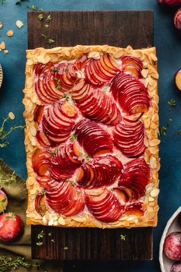 overhead photo of a rustic plum tart with almonds