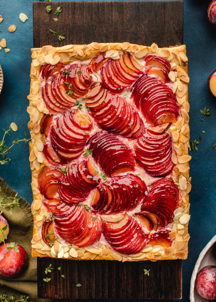 rustic plum tart on a cutting board