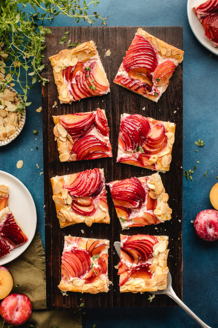 slices of plum almond tart on a wooden board