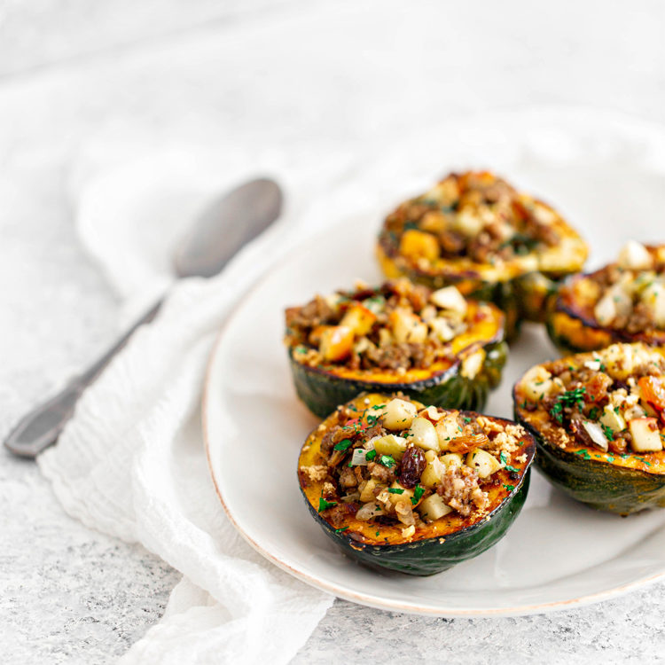 white platter with sausage and apple stuffed acorn squash