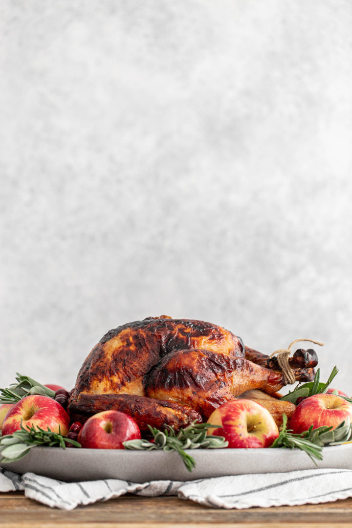 seasoned turkey for thanksgiving on a grey platter 