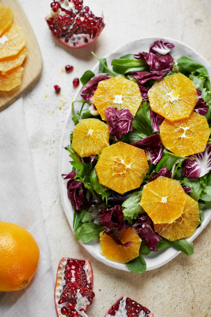 mixed greens and arugula topped with orange slices