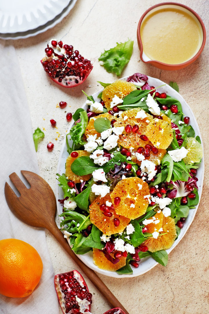 citrus green salad with goat cheese on a platter