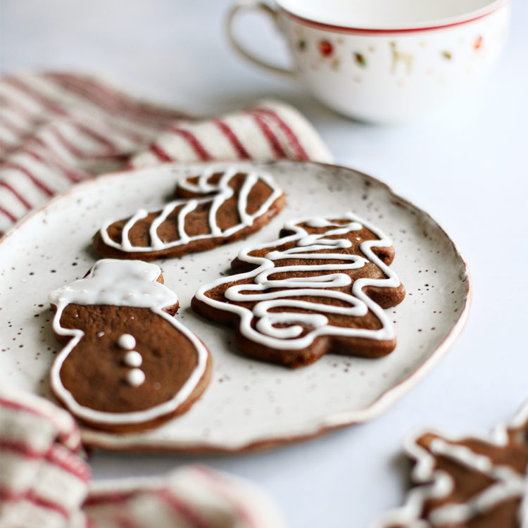 a plate of decorated gingerbread cookies