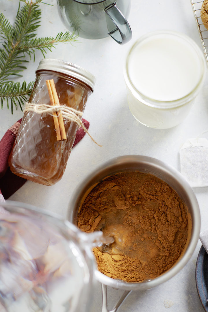 woman adding ingredients to a pot