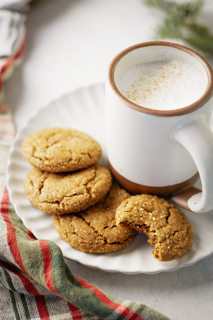 homemade gingersnaps cookies on a plate with a latte