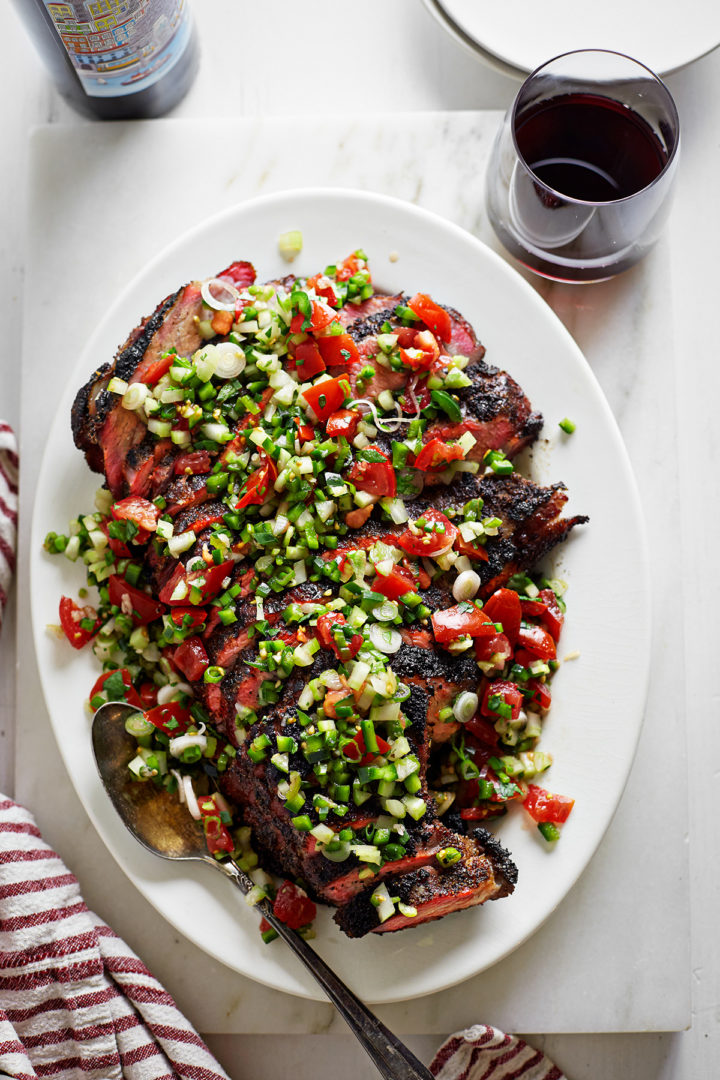 santa maria style tri tip with fresh salsa topping on a white platter