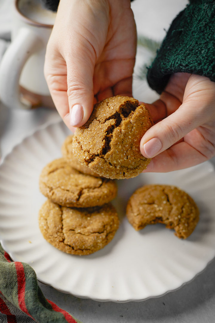 woman eating a plate of soft and chewy gingersnaps cookies